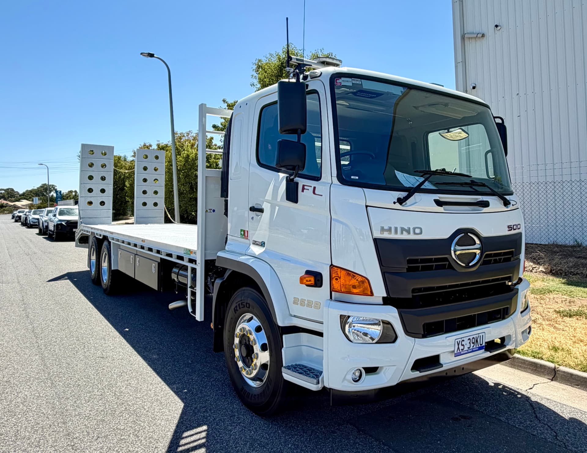Hino 500 2628 beavertail truck with loading ramps delivered