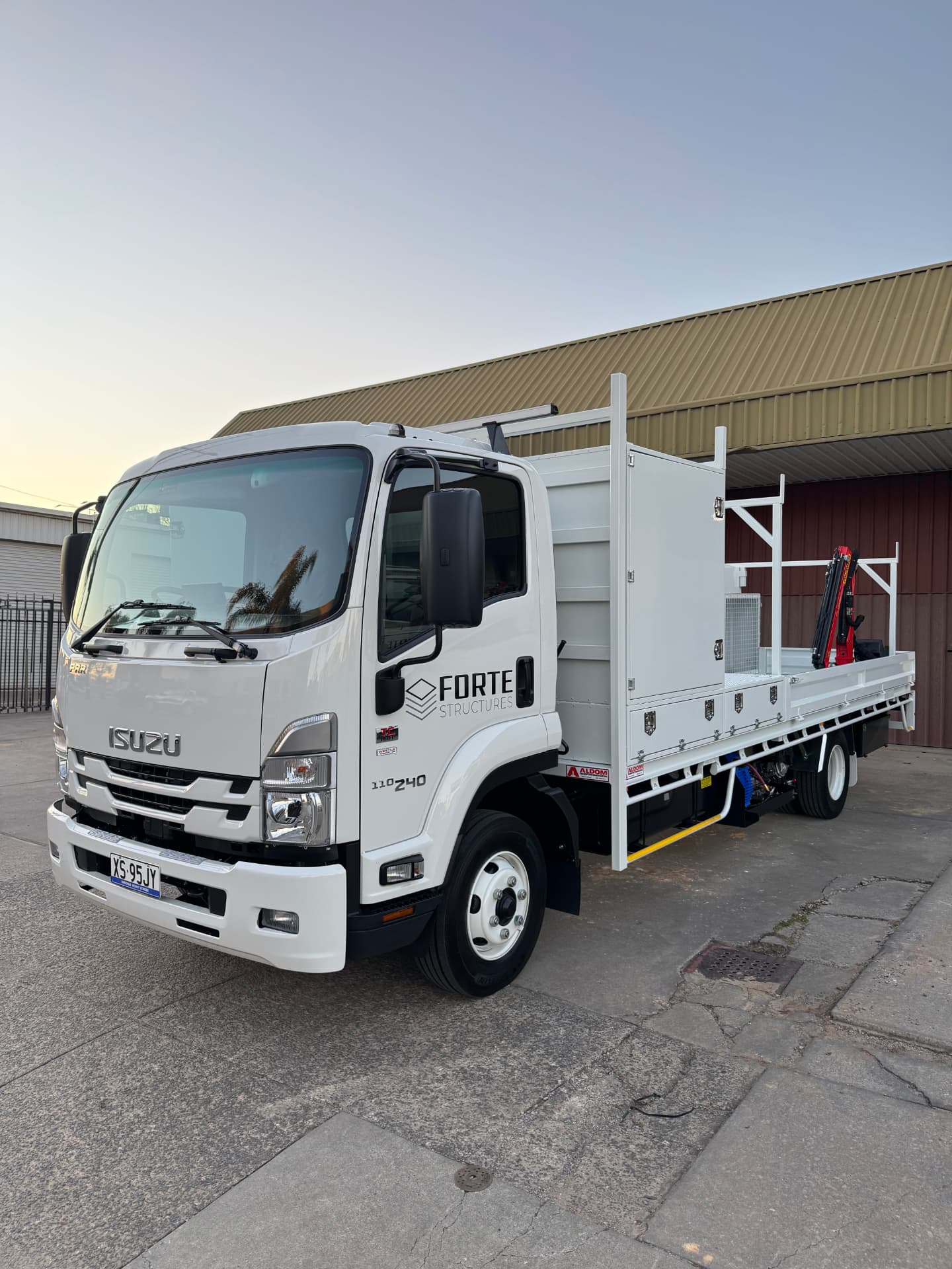 Isuzu FRR service body truck with crane delivered to Forte Structures