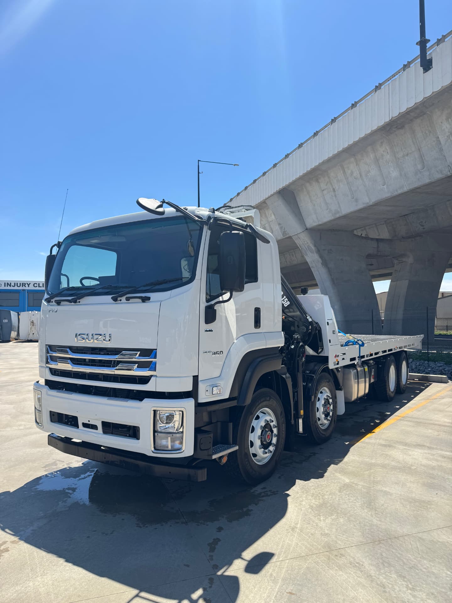 Isuzu FYJ 8x4 crane truck with long tray delivered